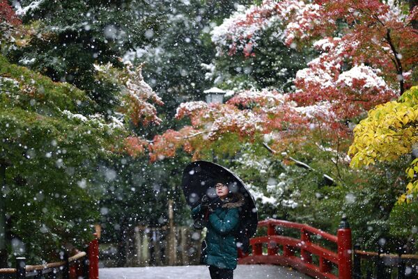 Посетительница Храма Цуругаока-Хатиман-гу во время снегопада в Камакуре, Япония