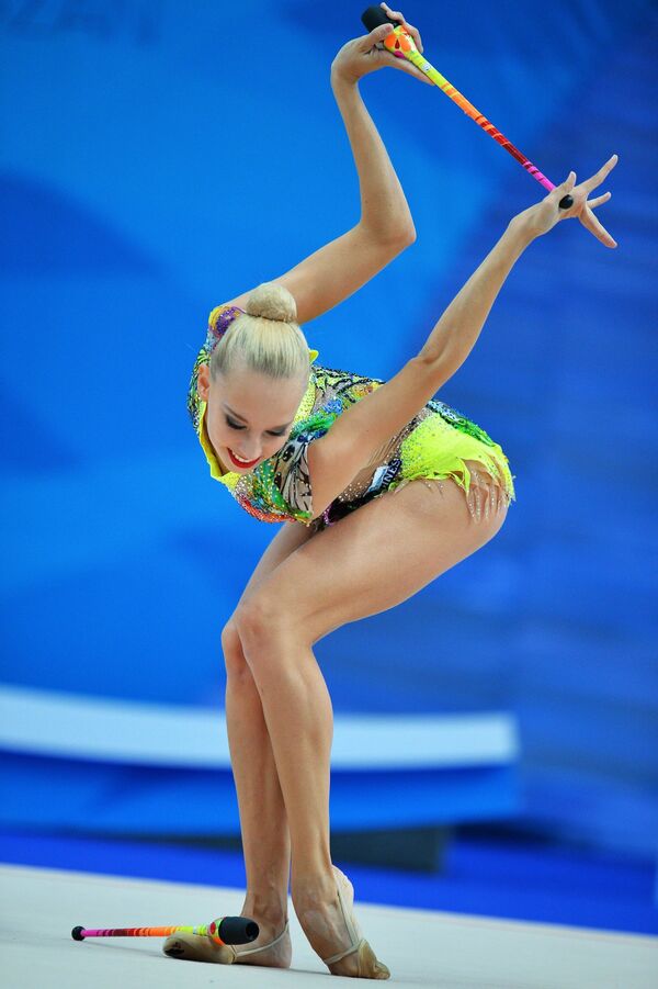 Яна Кудрявцева (Россия) выполняет упражнения с булавами в соревнованиях Кубка мира по художественной гимнастике в Казани