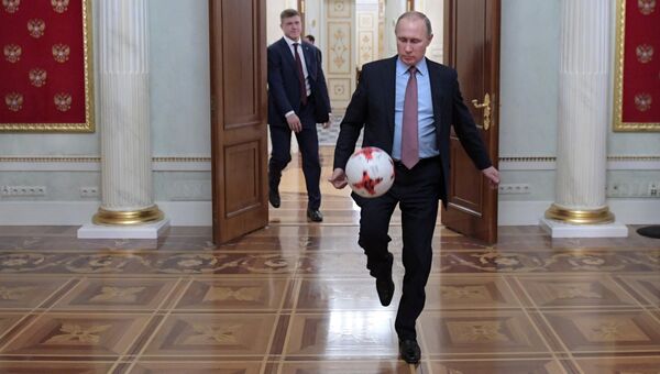 Президент РФ Владимир Путин с мячом после встречи в Кремле с президентом ФИФА Джанни Инфантино
