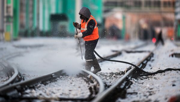 Рабочий очищает железнодорожный путь. Архивное фото