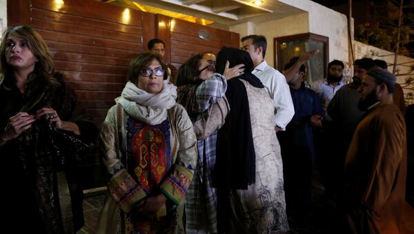 Родственники музыканта Джунейда Джамшеда собрались возле его дома в Карачи после сообщения о крушении самолета, Пакистан