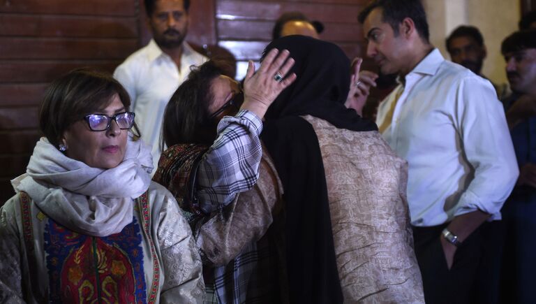 Родственники музыканта Джунейда Джамшеда собрались возле его дома в Карачи после сообщения о крушении самолета авиакомпании PIA, Пакистан