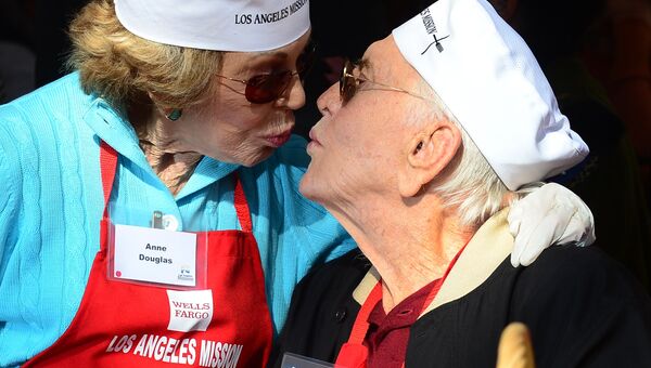 Актер Кирк Дуглас со своей женой Энн принимают участие в Праздничном благотворительном обеде для бездомных в день Благодарения в Лос-Анджелесе