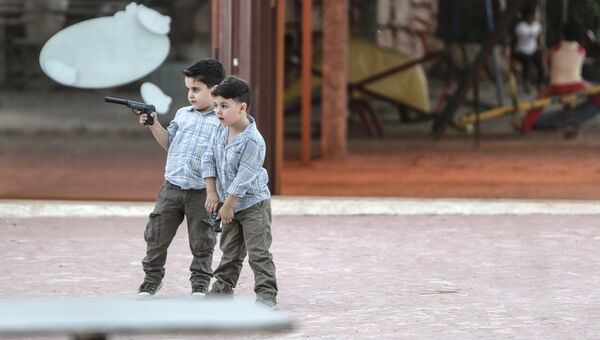 Мальчики с пистолетами играют в войну в Латакии