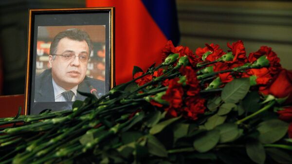Цветы у портрета посла России в Турции Андрея Карлова, убитого в Анкаре. Архивное фото