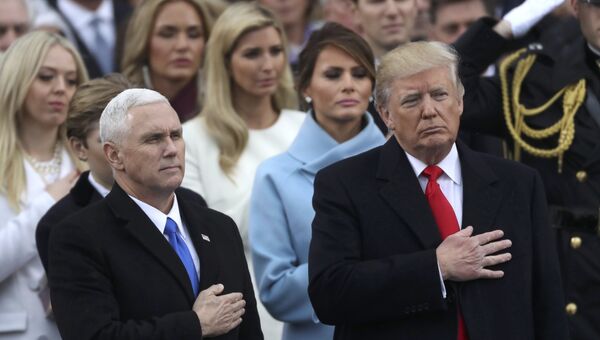 Президент США Дональд Трамп и вице-президент Майк Пенс слушают национальный гимн США во время церемонии инаугурации в Капитолии США в Вашингтоне. 20 января 2017