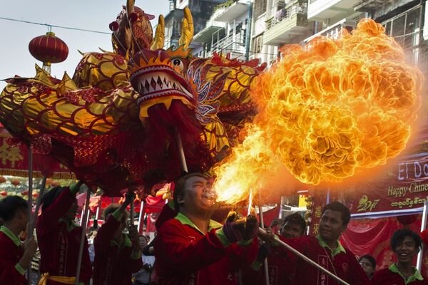 Традиционные танцы дракона и льва по улицам в первый день Нового года в китайском квартале Янгона, Мьянма. 28 января 2017 года