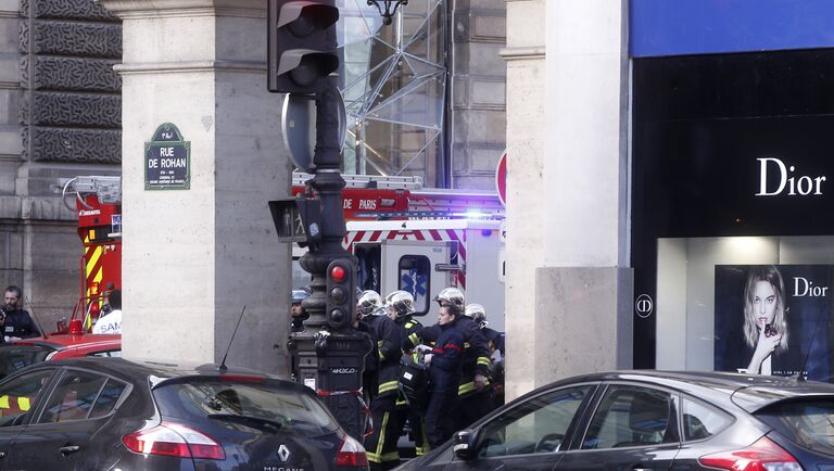 Спасатели несут носилки возле здания Лувра в Париже, где неизвестный напал на военнослужащего, Франция. 3 февраля 2017