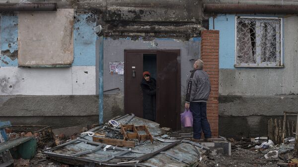 Жители Донецка у подъезда дома, поврежденного в результате обстрелов