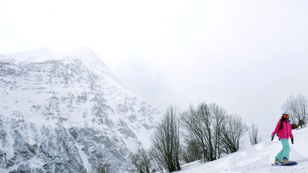 Сноубордист скатывается с горы Чегет. Архивное фото