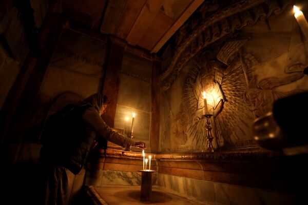 Верующая молится в Кувуклии в храме Гроба Господня