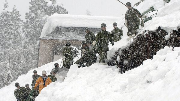 Спасатели на месте схода снежной лавины в Японии
