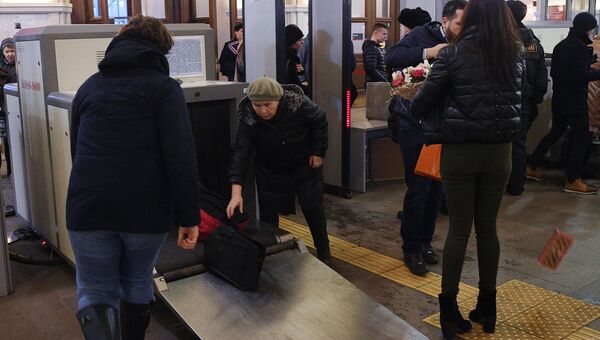 Сотрудники службы безопасности досматривают багаж пассажиров в здании Ленинградского вокзала в Москве