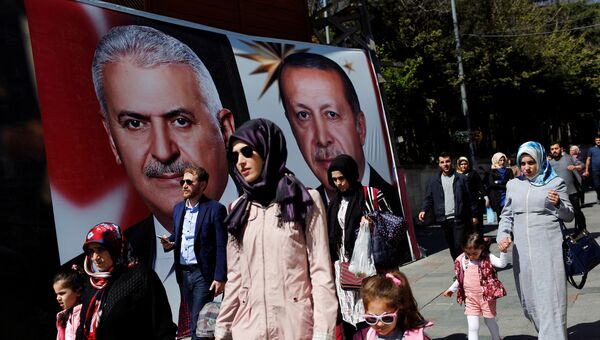 Прохожие на улице Стамбула накануне референдума в Турции. 13 апреля 2014 года