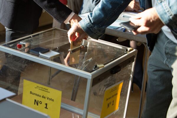 Мужчина голосует на избирательном участке в Париже во время первого тура президентских выборов во Франции
