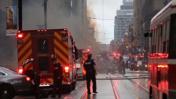 Полиция и пожарные на месте взрыва в финансовом районе Торонто, Канада. 1 мая 2017