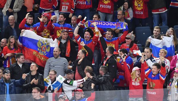 Российские болельщики скандируют Шайбу-шайбу, размахивают триколором и надеются на победу.