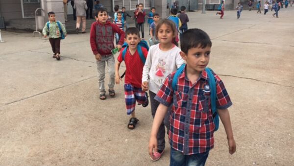 Дети покидают школу после окончания учебного дня в лагере для беженцев. Архивное фото