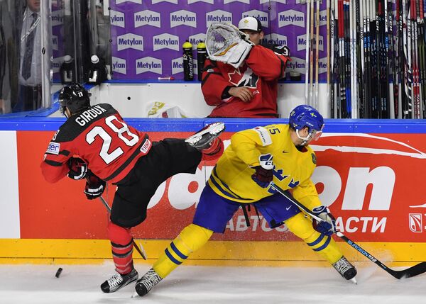 Игрок сборной Канады Клод Жиру и игрок сборной Швеции Оскар Линдберг (справа) в финальном матче чемпионата мира по хоккею 2017 между сборными командами Канады и Швеции