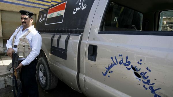Сотрудник полиции в городе Эль-Мусайиб, Ирак