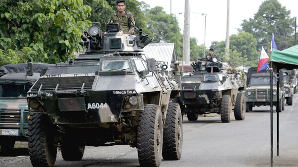 Военный конвой на окраине города Марави, на юге Филиппин. 9 июня 2017
