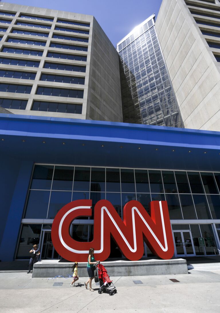 Прохожие у здания штаб-квартиры CNN в Атланте, США Прохожие у здания штаб-квартиры CNN в Атланте, США
