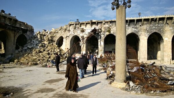 Жители Алеппо во дворе старейшей Мечети Омейядов, разрушенной в результате боевых действий. Архивное фото