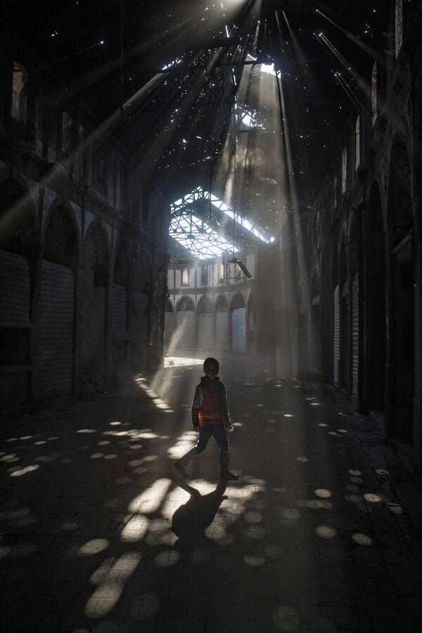Дети играют в одном из зданий разрушенного района Хомса аль Хамидия.  Сирия,  12.12.2015