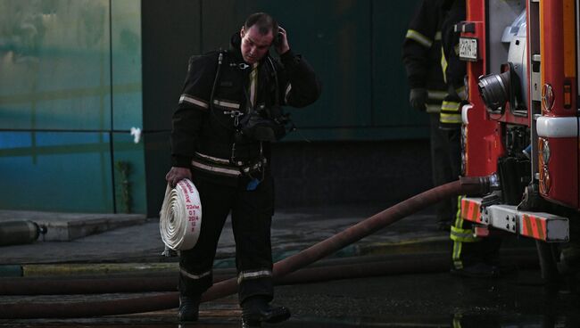 Сотрудник противопожарной службы во время тушения пожара в здании торгового центра РИО на Дмитровском шоссе в Москве