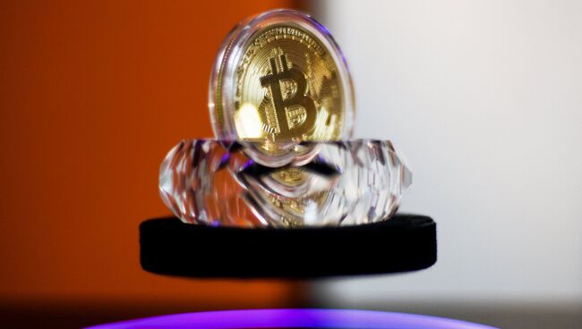 Сувенирная монета криптовалюты биткойн в MaRSe Bitcoin Center в Москве. Архивное фото