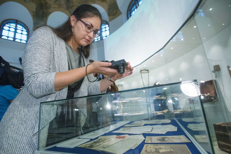 Посетительница фотографирует документы из архива семьи Романовых, переданного музею-заповеднику Царское село и выставленного в экспозиции Россия в Великой войне