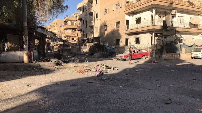 Последствия ракетного обстрела квартала Аль-Кусур в Дейр-эз-Зоре. Архивное фото