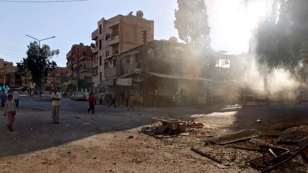 Последствия ракетного обстрела квартала Аль-Кусур в сирийском Дейр-эз-Зоре. Архивное фото