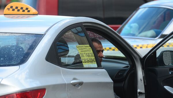 Водитель такси в ожидании пассажиров. Архивное фото