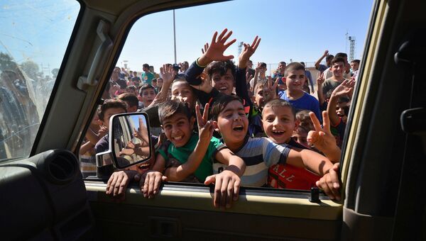 Дети приветствуют автомобили членов служб безопасности Ирака в Киркуке