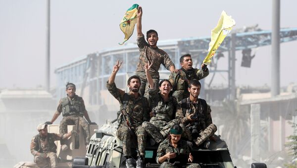 Военнослужащие Сирийских демократических сил празднуют победу в Ракке, Сирия. 17 октября 2017