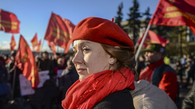 Участница митинга в честь 100-летия Великой Октябрьской социалистической революции у Финляндского вокзала в Санкт-Петербурге. 7 ноября 2017