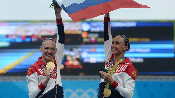 Светлана Ромашина и Наталья Ищенко (Россия), завоевавшие золотые медали на соревнованиях по синхронному плаванию среди дуэтов на XXXI летних Олимпийских играх, во время церемонии награждения. 2016 год