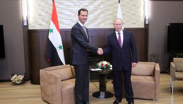 Президент РФ Владимир Путин и президент Сирии Башар Асад во время встречи. Архивное фото