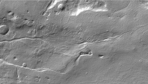 Длинный овраг в центре фотографии – след движения талой воды по поверхности Марса. Снимок зонда MRO