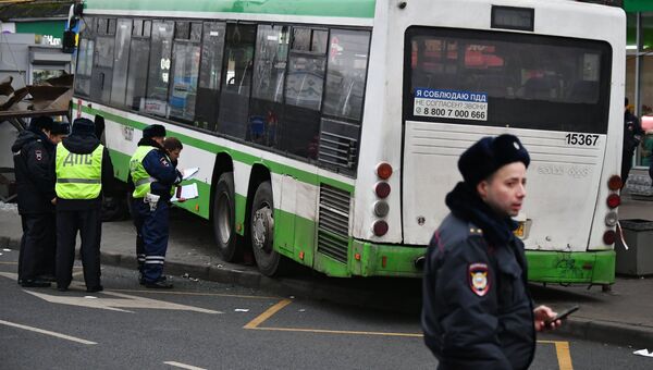 Сотрудники правоохранительных органов у пассажирского автобуса, въехавшего в остановку на Сходненской улице в Москве. 29 декабря 2017