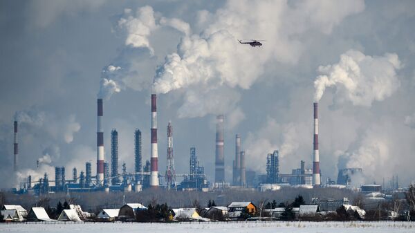 Трубы и вышки сжигания попутного газа Омского нефтеперерабатывающего завода.