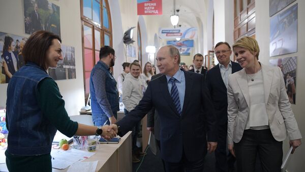 Президент РФ Владимир Путин и  Елена Шмелева во время посещения своего предвыборного штаба в Гостином дворе в Москве. Архивное фото