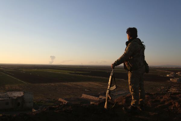 Сирийский боец наблюдает за районом Африна