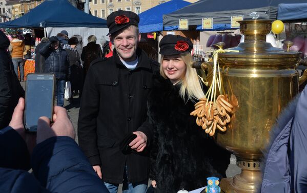 Посетители праздничной ярмарки Широкой Масленицы на центральной площади Владивостока. 17 февраля 2018