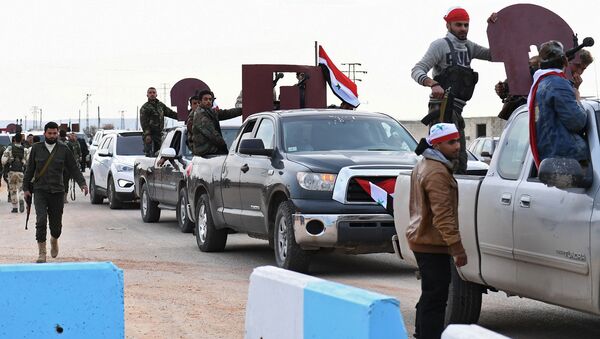 Курдские бойцы приветствуют конвой просирийских правительственных сил, прибывающих в сирийский Африн. 20 февраля 2018