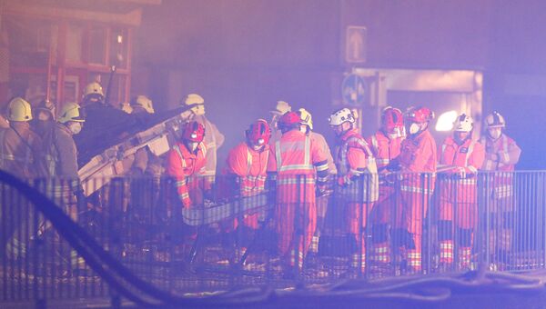 Спасатели на месте взрыва, который уничтожил магазин и дом в Лестере, Британия. 25 февраля 2018