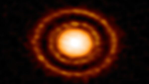 Протопланетный диск AS 209, расположенный в 410 световых годах от Солнца снятый телескопом ALMA