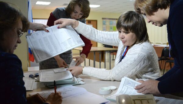 Члены избирательной комиссии во время подсчета голосов на одном из избирательных участков во Владивостоке. 18 марта 2018