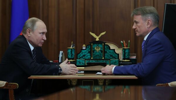 Владимир Путин и президент, председатель правления ОАО Сбербанк России Герман Греф во время встречи. 21 марта 2018